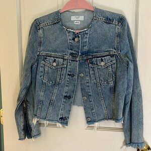 Raw edged denim jacket with zipper details.